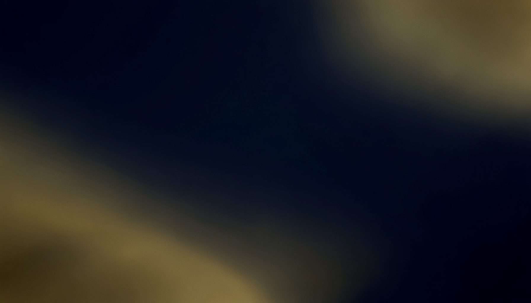 Abstract composition of deep navy and muted gold tones, smooth gradients evoking a cinematic late-night mood